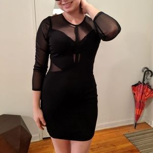 Body-con black cocktail dress with mash sleeve.